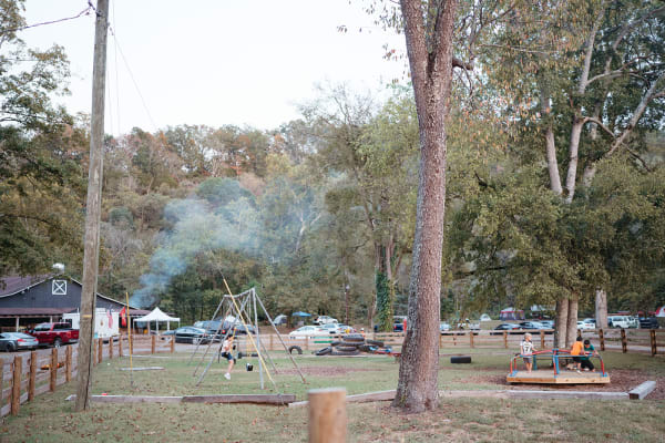 Campfire smoke drifting over the grounds at dusk