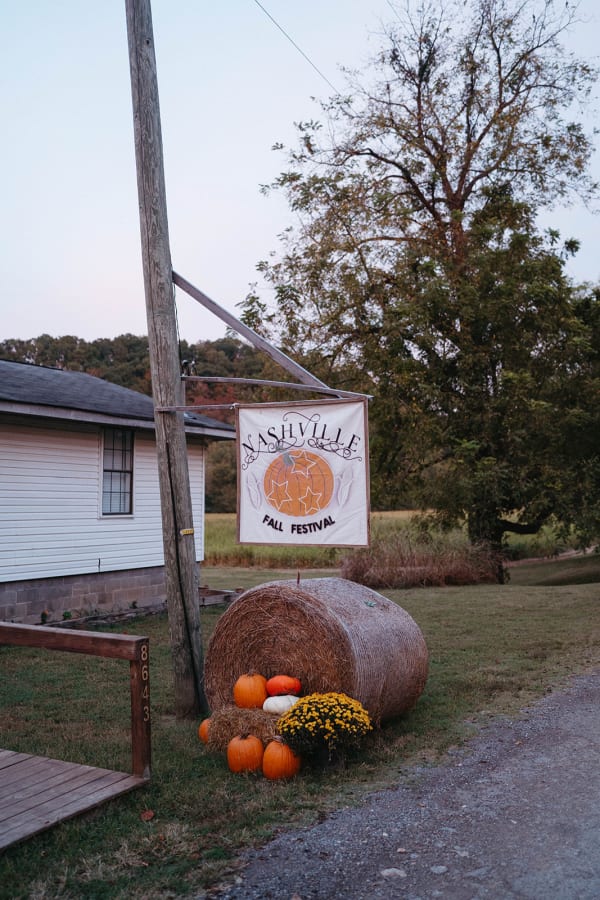 Festival sign with a hay bale and pumpkins