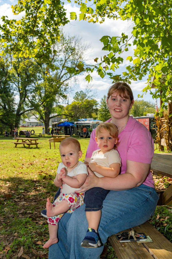 Mom with her two babies on a bench