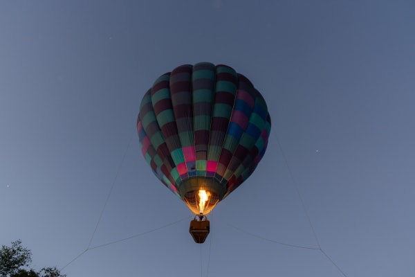 Hot air balloon glowing at dusk