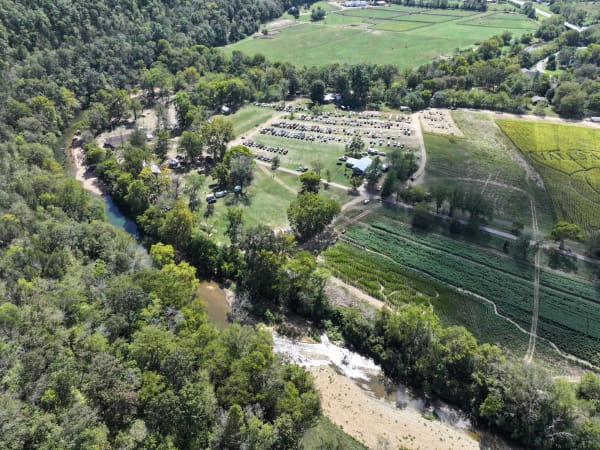 Wide aerial view of the farm, river and corn maze