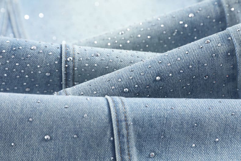 YEEYEEWang Wide-Leg Jeans, Asian-fit cut, close-up of folded denim with fine twill texture and scattered crystal embellishments.