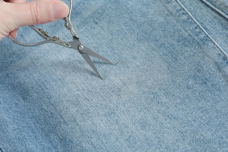 YEEYEEWang Denim Bermuda Shorts, Asian-fit cut, close-up of dense twill weave fabric surface with fine diagonal texture.
