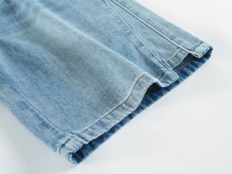 YEEYEEWang Denim Bermuda Shorts, Asian-fit cut, close-up of leg opening hems with even twin stitching and tidy inner seams.