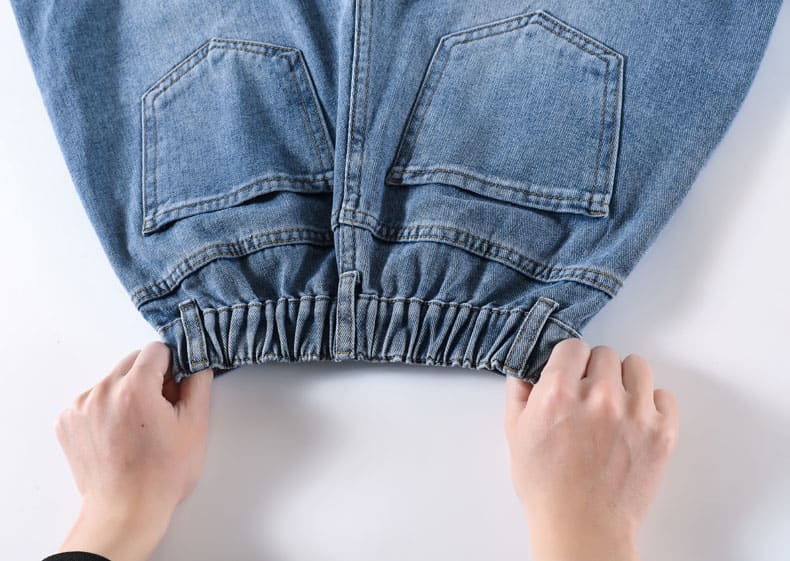 YEEYEEWang Denim Bermuda Shorts, Asian-fit cut, two hands stretching the shirred elastic back waistband.