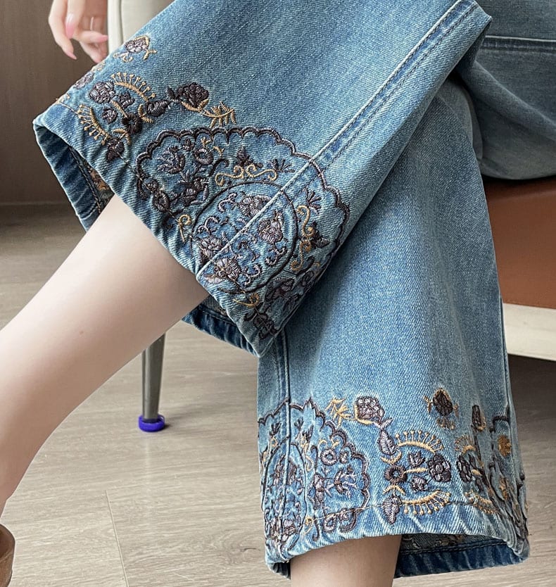 YEEYEEWang Straight-Leg Jeans, Asian-fit cut, close-up of seated model showing intricate floral medallion embroidery along the hem.