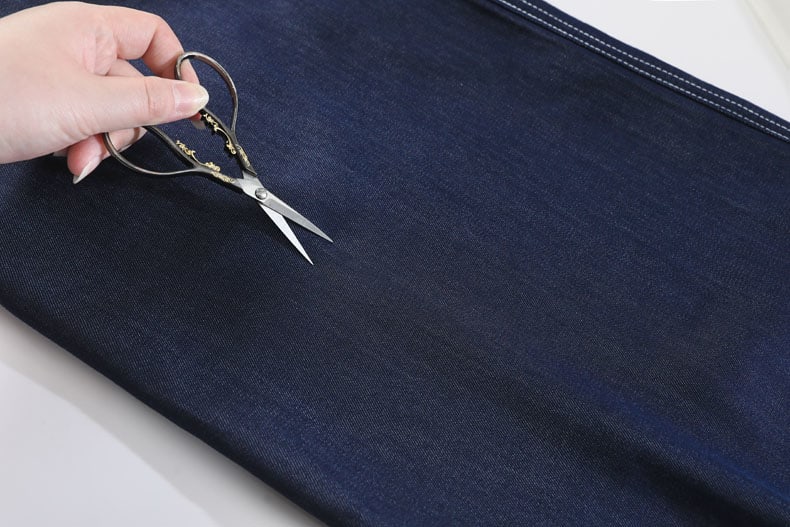 YEEYEEWang Wide-Leg Jeans in Denim Blue, Asian-fit cut, macro close-up of dense twill weave surface with fine diagonal grain.