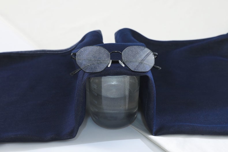 YEEYEEWang Wide-Leg Jeans in Denim Blue, Asian-fit cut, fabric draped over a cup of hot water with condensation visible on eyeglass lenses.