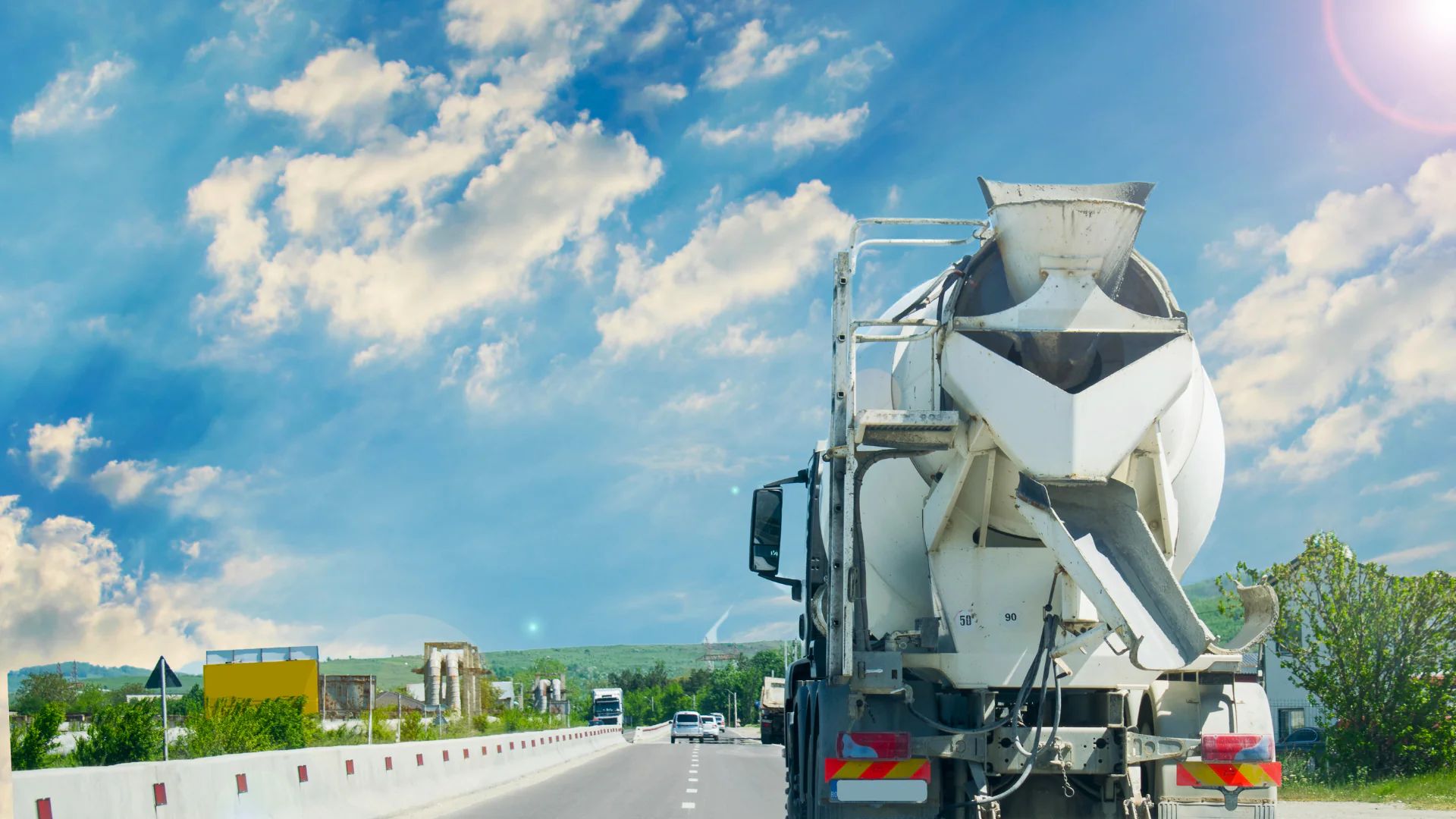 Ready-mix concrete trucks queued at a batch plant loading bay before dispatch