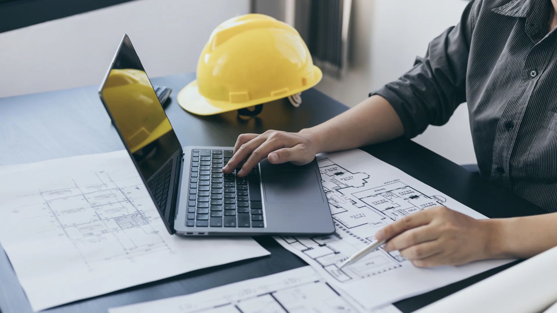Roofing estimator reviewing a job from the office instead of measuring by hand on the roof