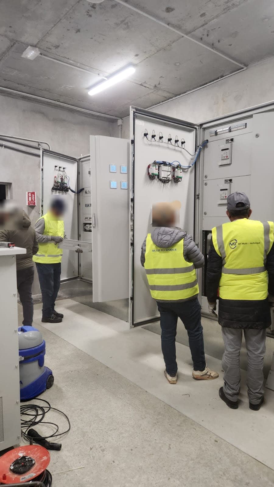 Local TGBT avec armoires de distribution ouvertes pendant une intervention de contrôle
