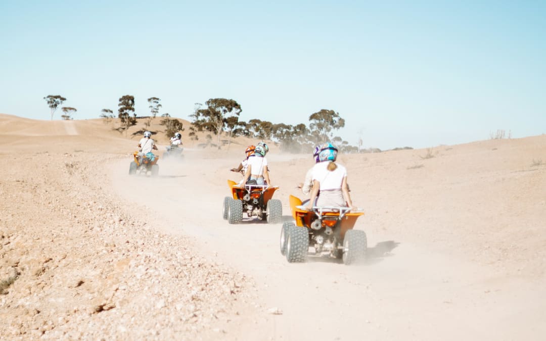 Group riding quads on a track