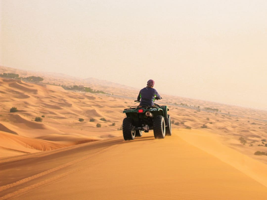 Quad bike on a dune ridge