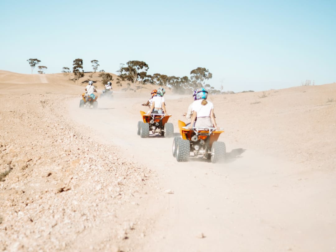 Group riding quads on a track