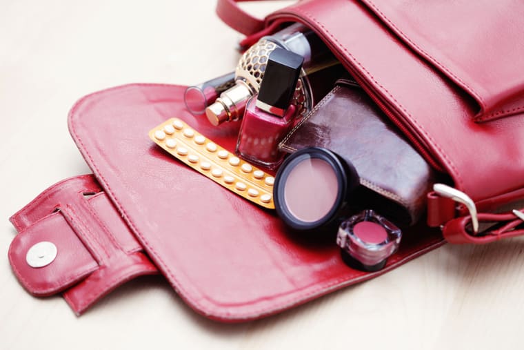 birth control pill in handbag - healthcare and medicine