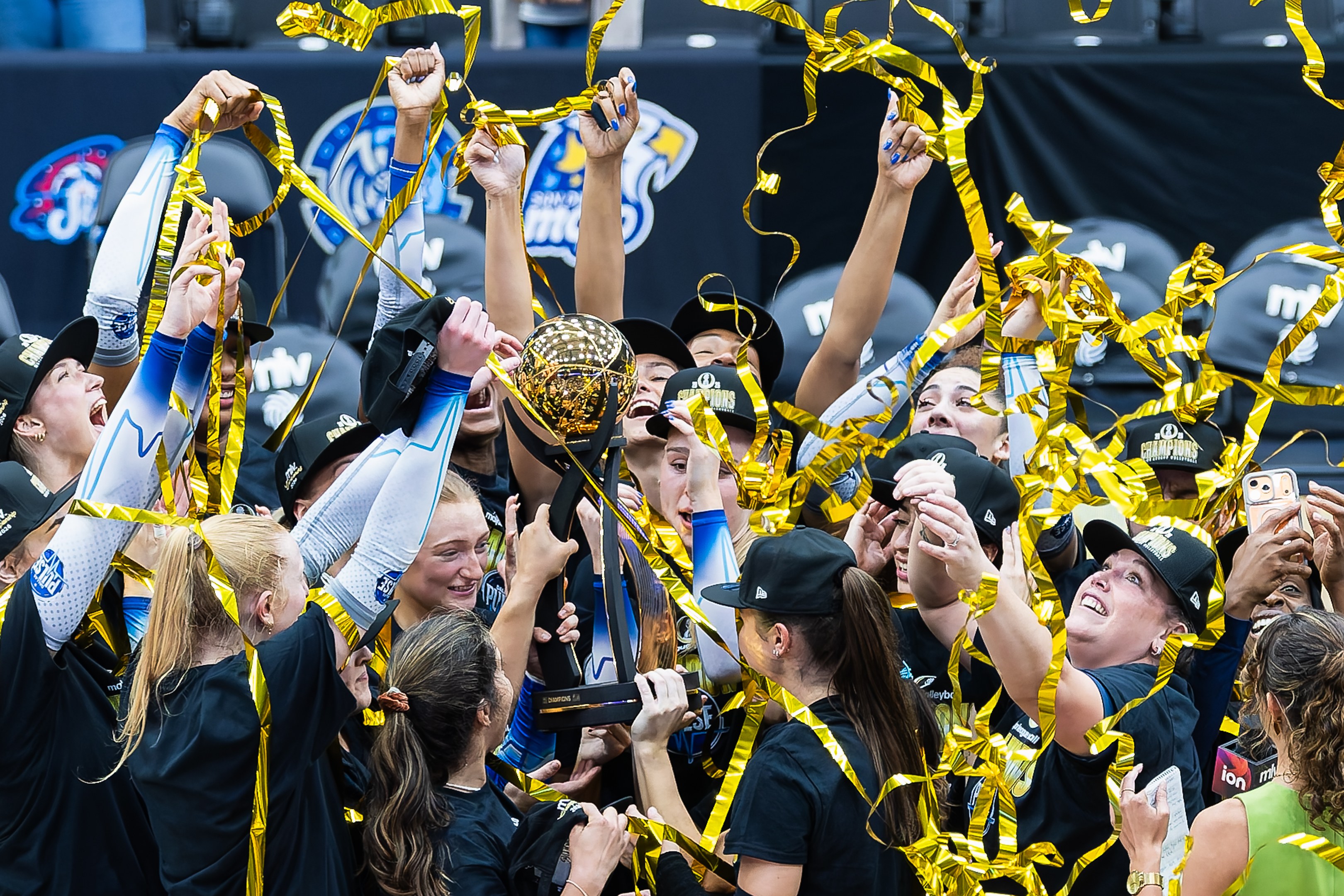 The Dallas Pulse hoist the 2026 MLV Championship trophy amid gold confetti at Comerica Center in Frisco, Texas, after their five-set win over the Omaha Supernovas.