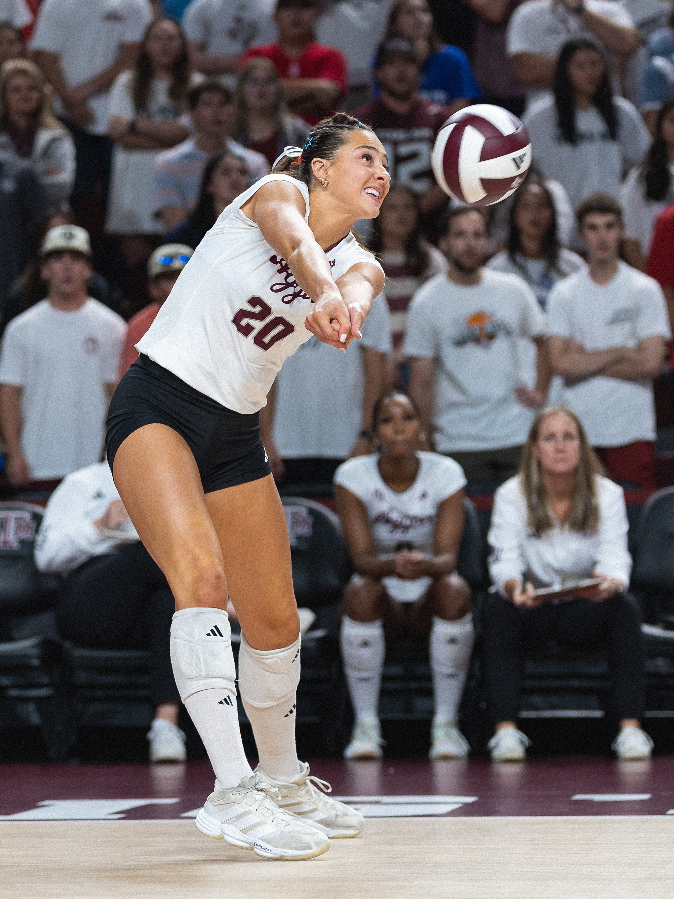 Texas A&M volleyball player passing the ball during a match against Wisconsin