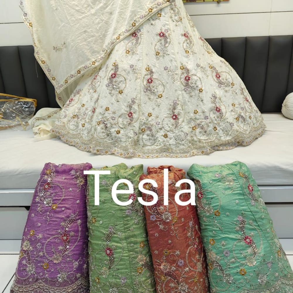 Ivory, with accents of red, gold, and green. Additional fabric swatches showcase purple, green, rust, and teal. Lehenga Choli