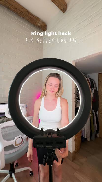 Creator using a ring light to film a viral TikTok video