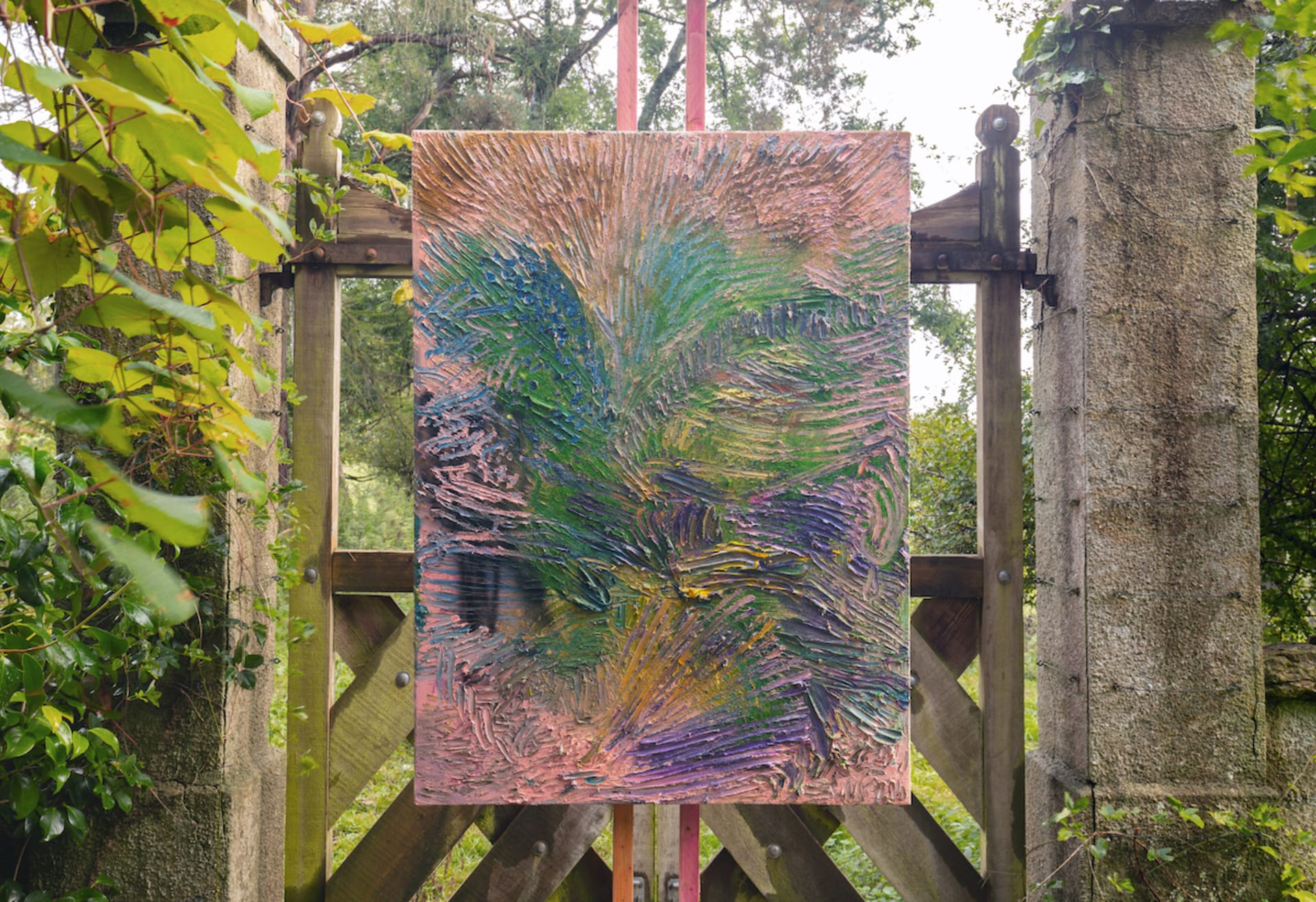 Artworks by James Cabaniuk installed outside in a lush green garden