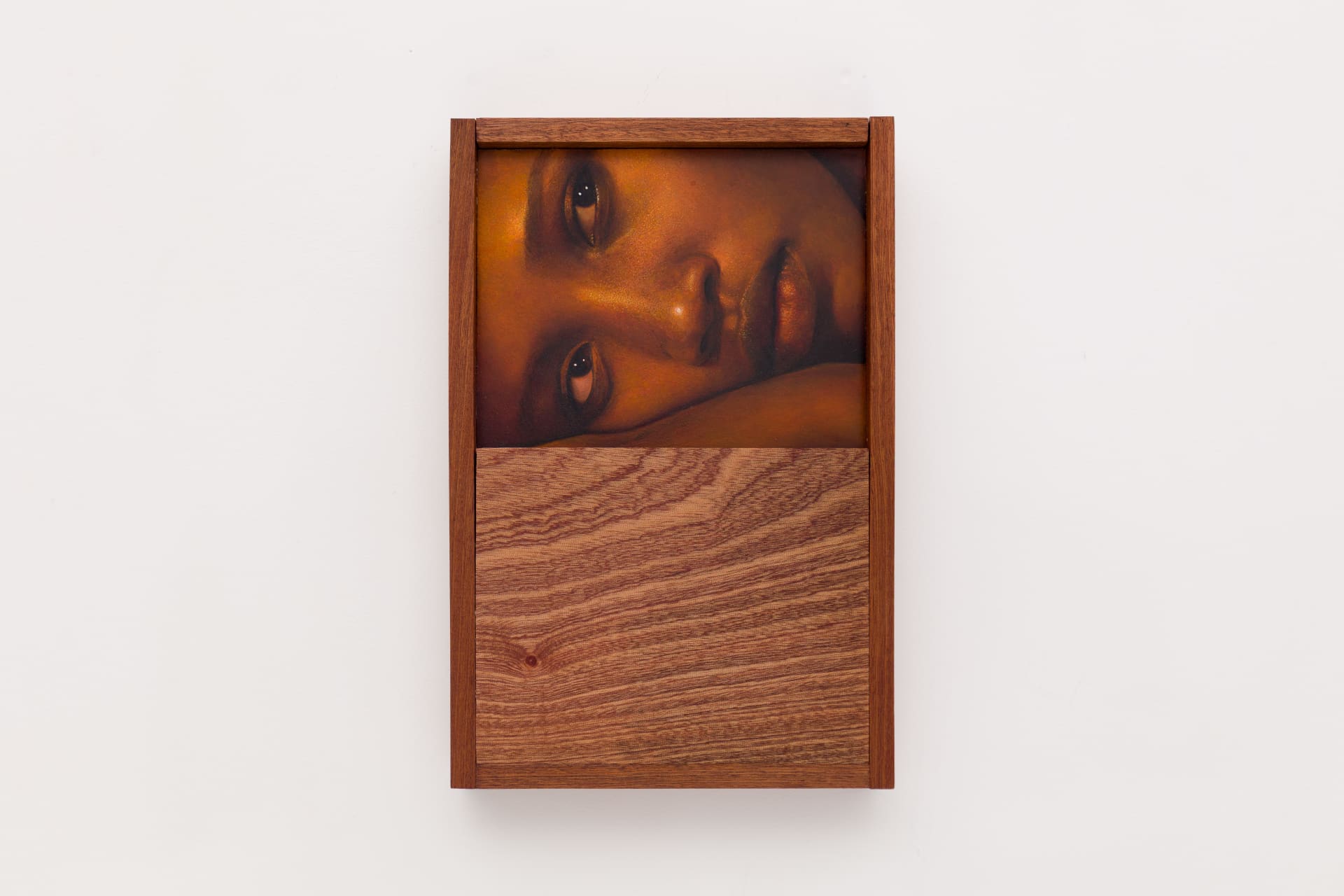 A close-cropped oil on board portrait by Ki Yoong of a young Black woman lying on her side, incorporating a hardwood frame and lower panel