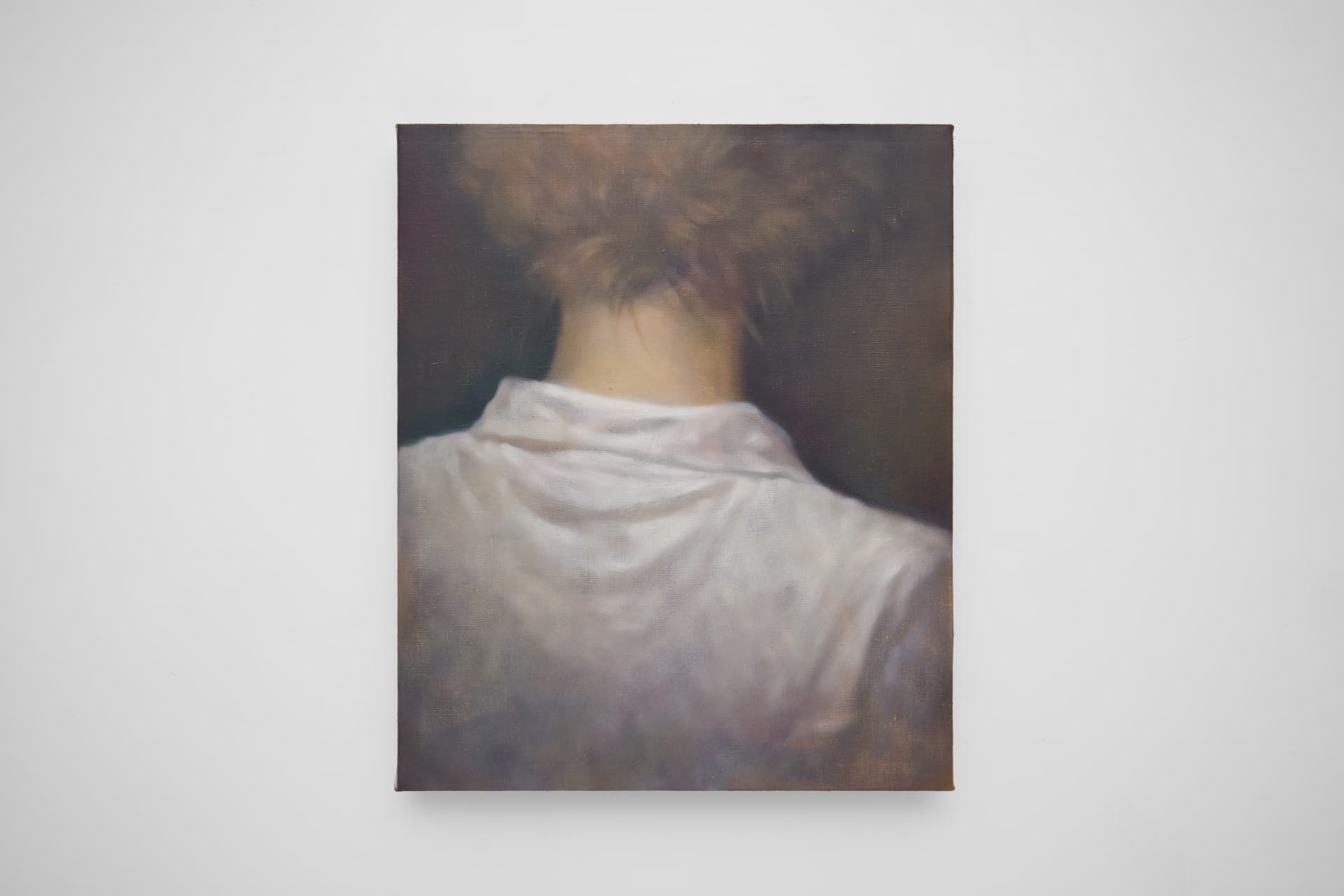 Short haired person from behind wearing white cotton shirt 