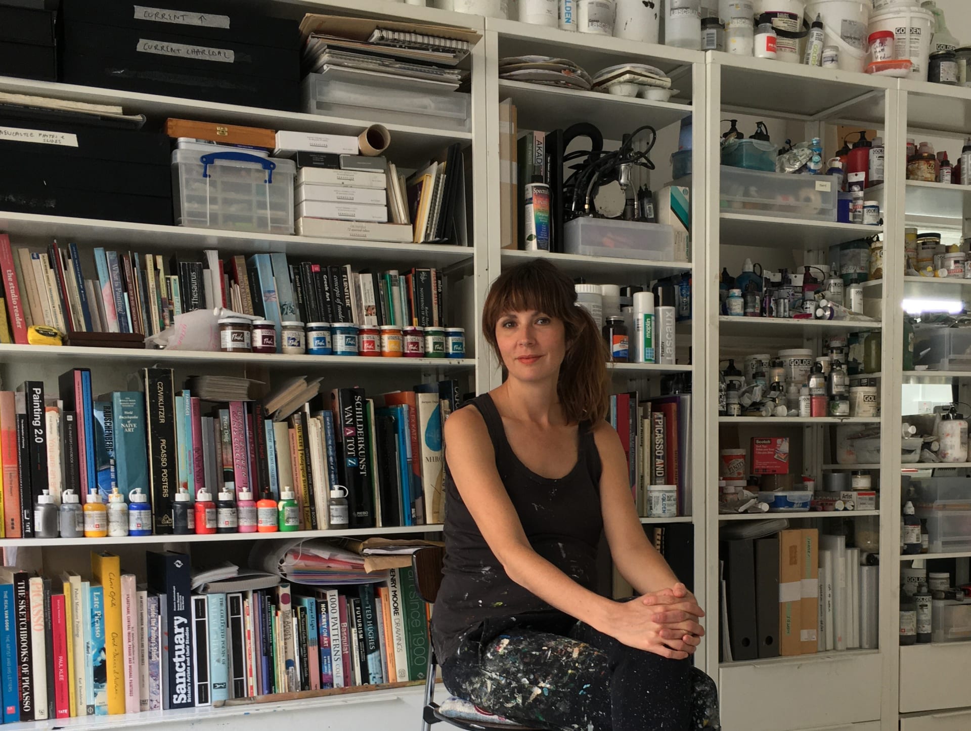A portrait of Phoebe Unwin sat in front of a bookshelf
