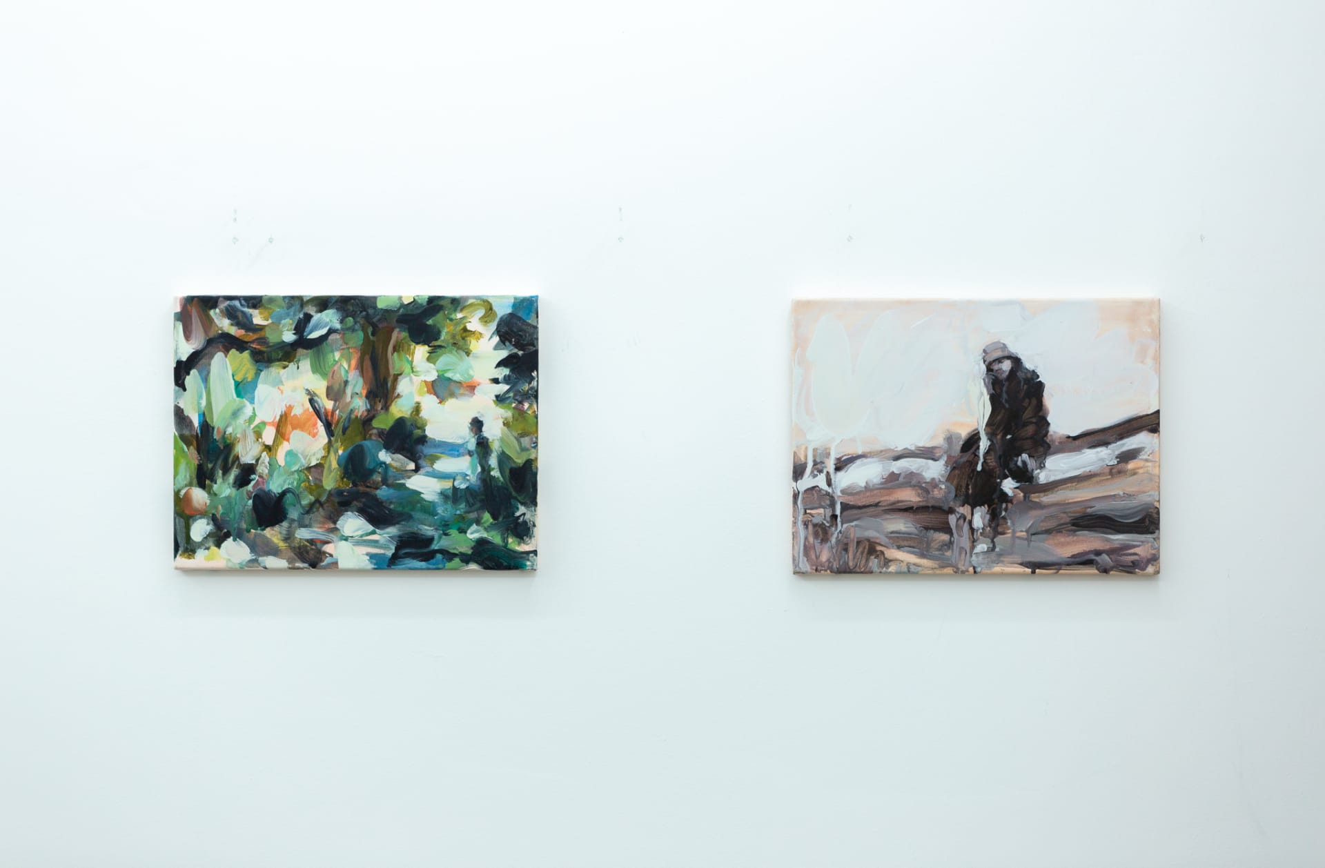 Installation shots of Laura Lancaster's solo show at Workplace London. Close up crop paintings of sleeping women and figures in landscapes, loosely painted.
