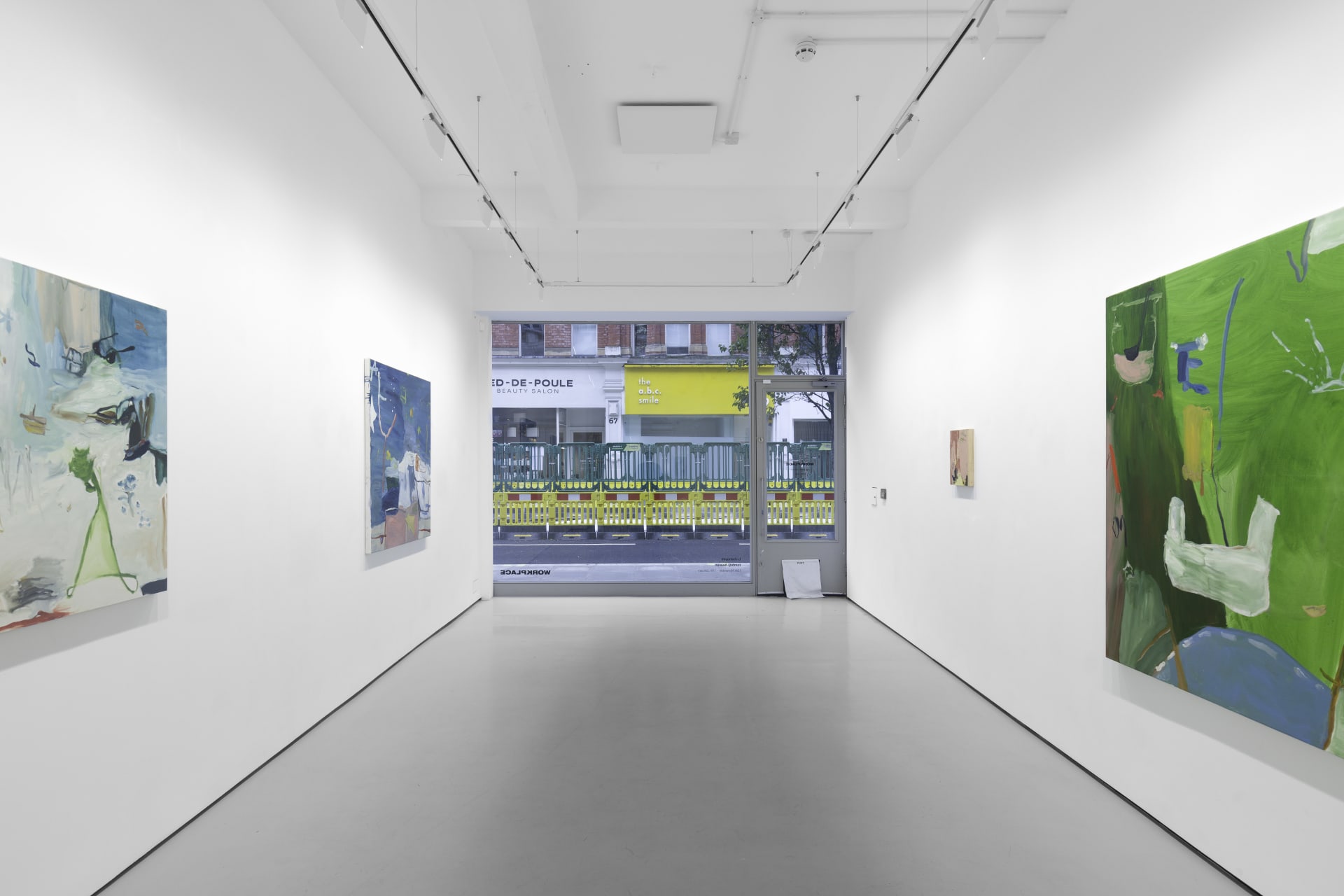 A white walled gallery with 4 artworks by b chehayeb hung on the walls