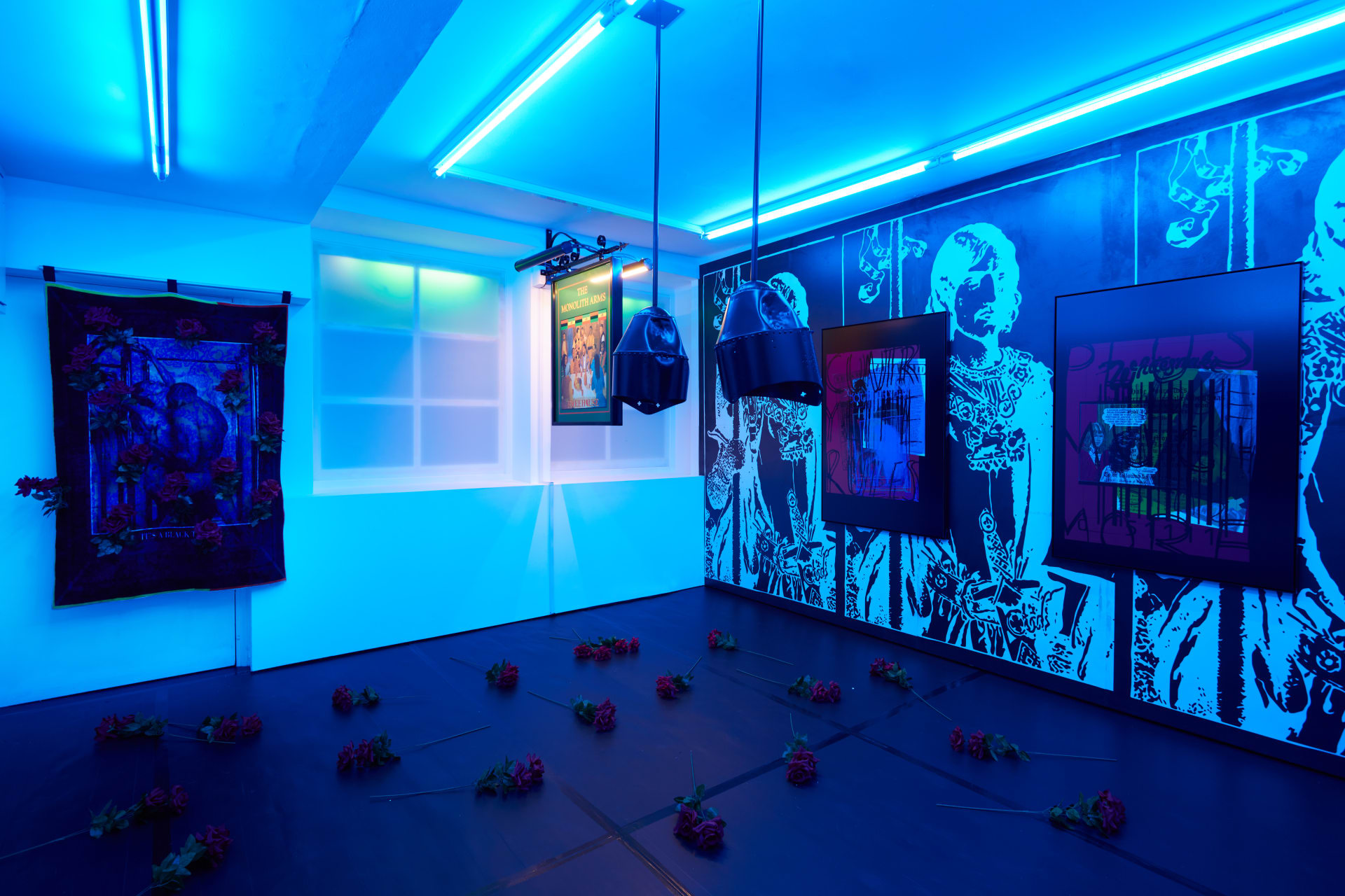 Installation images of Simeon Barclay's exhibition at Workplace in London, artworks, sculpture and video are cast in filtered blue light of a night club