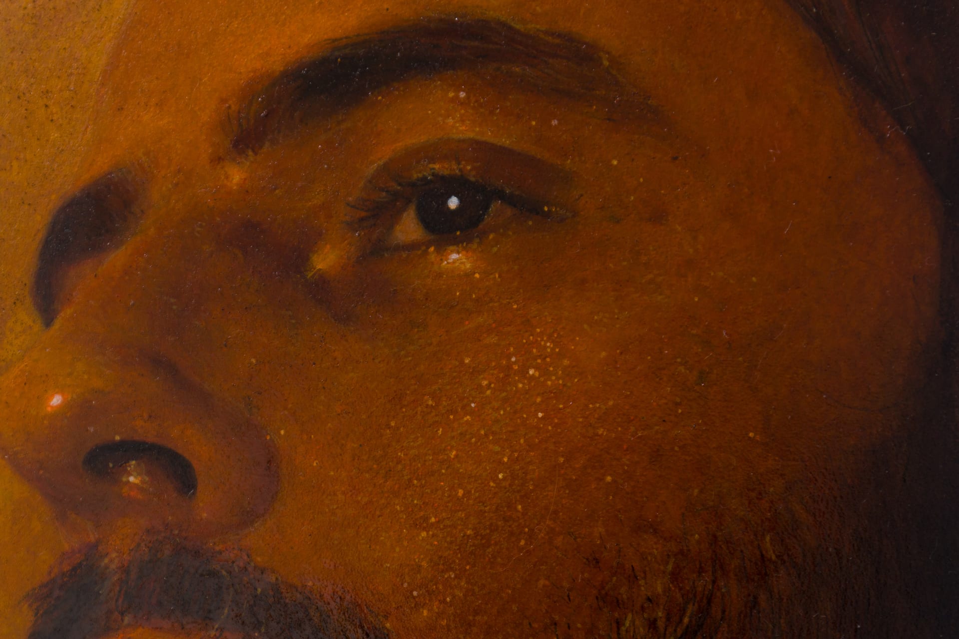 A painting by Ki Yoong of a softly lit young man's face with steel brackets attached to the top and bottom