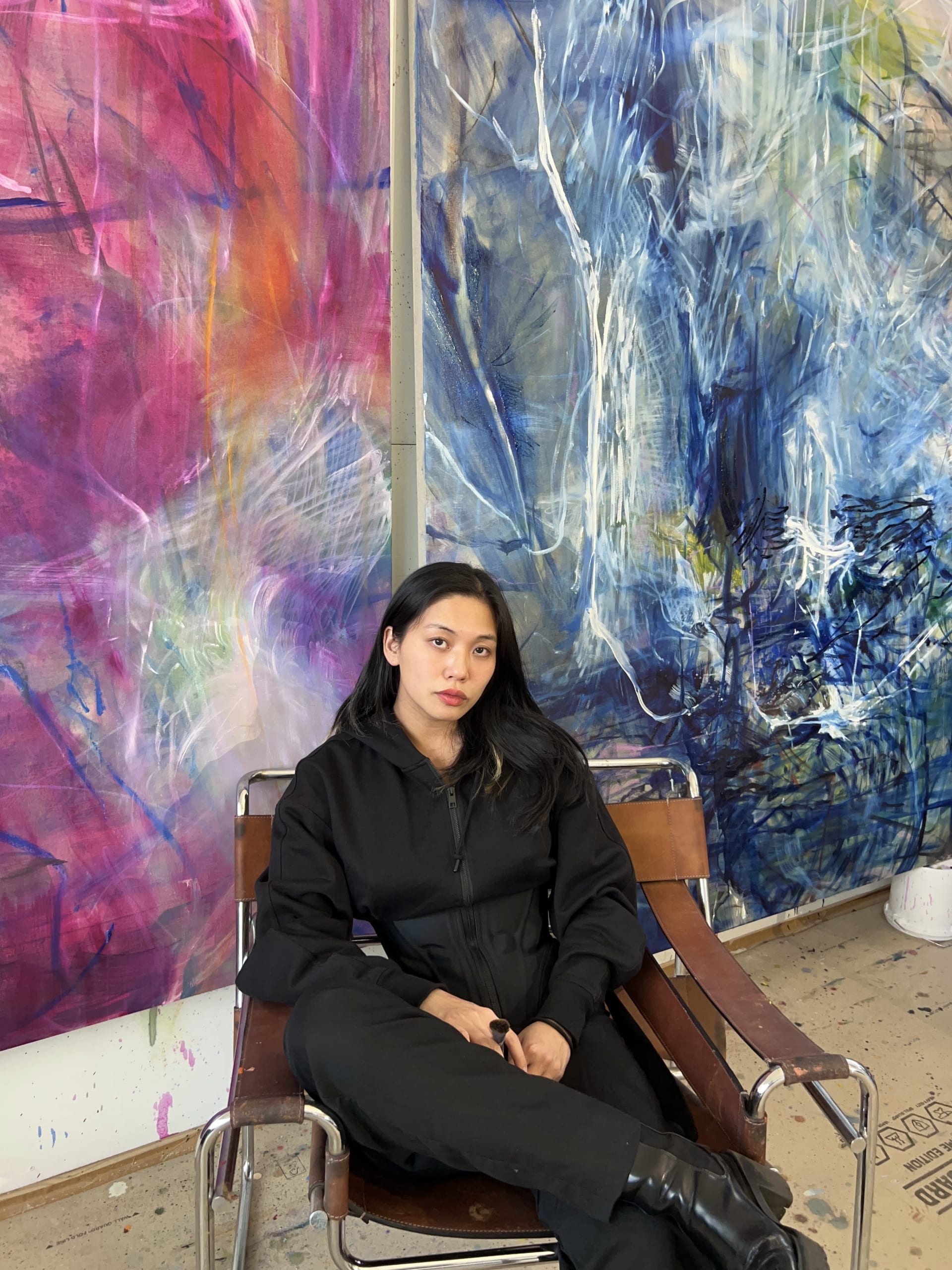 A portrait of Kristy M Chan sat in her studio