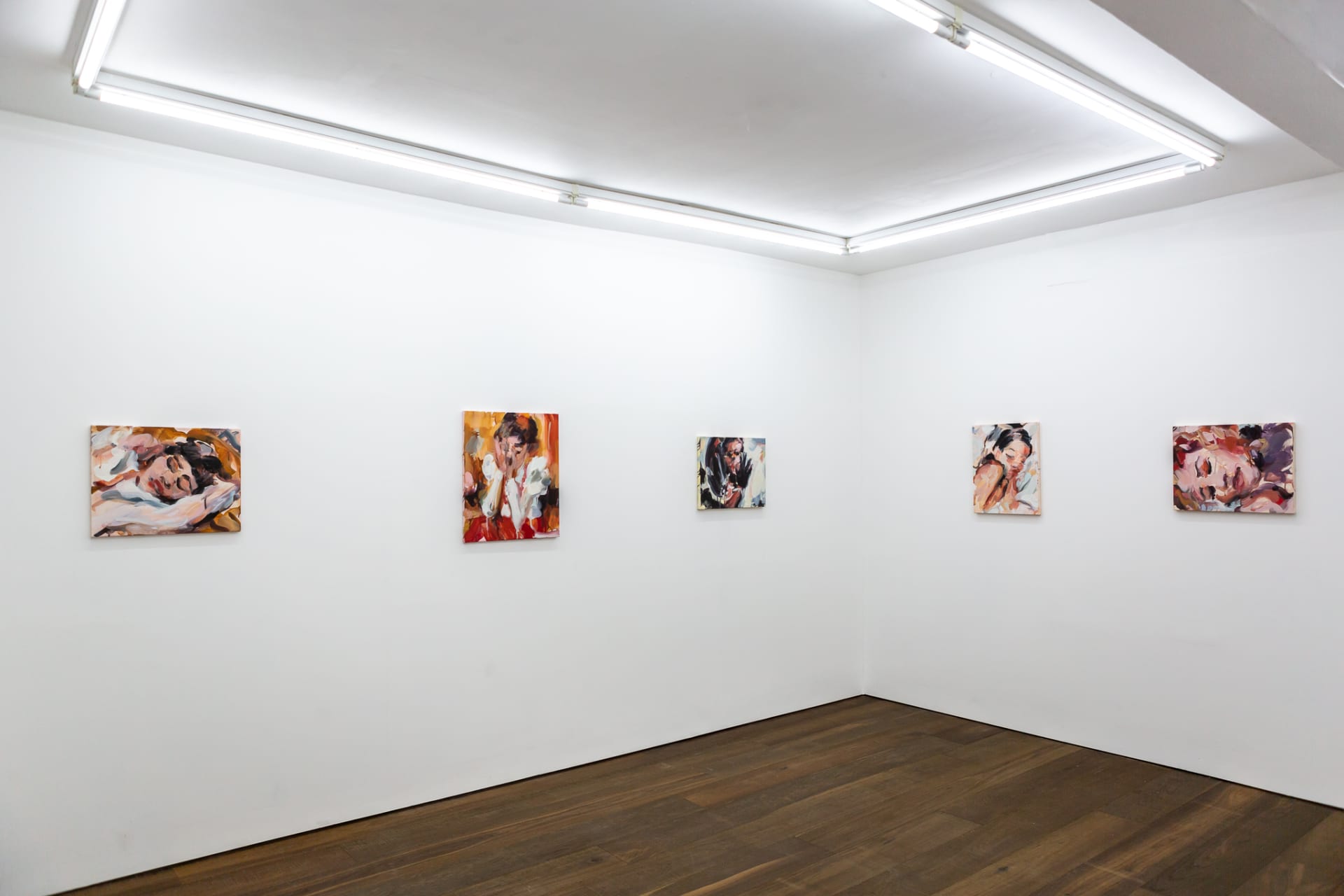 Installation shots of Laura Lancaster's solo show at Workplace London. Close up crop paintings of sleeping women and figures in landscapes, loosely painted.