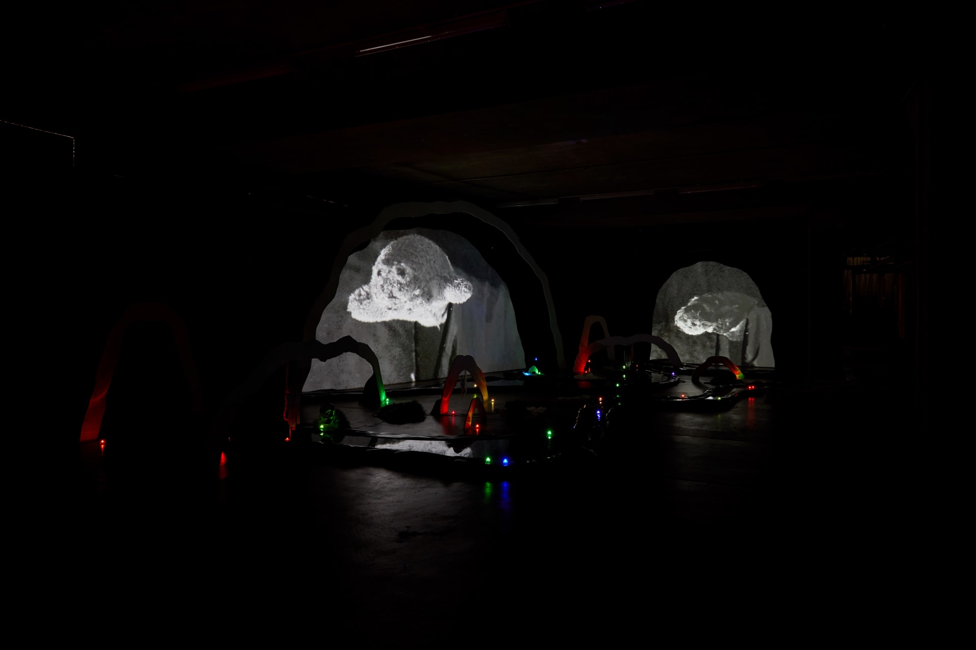 An installation by Hazel Brill of a number of amorphous forms with abstracted imagery projected onto them 