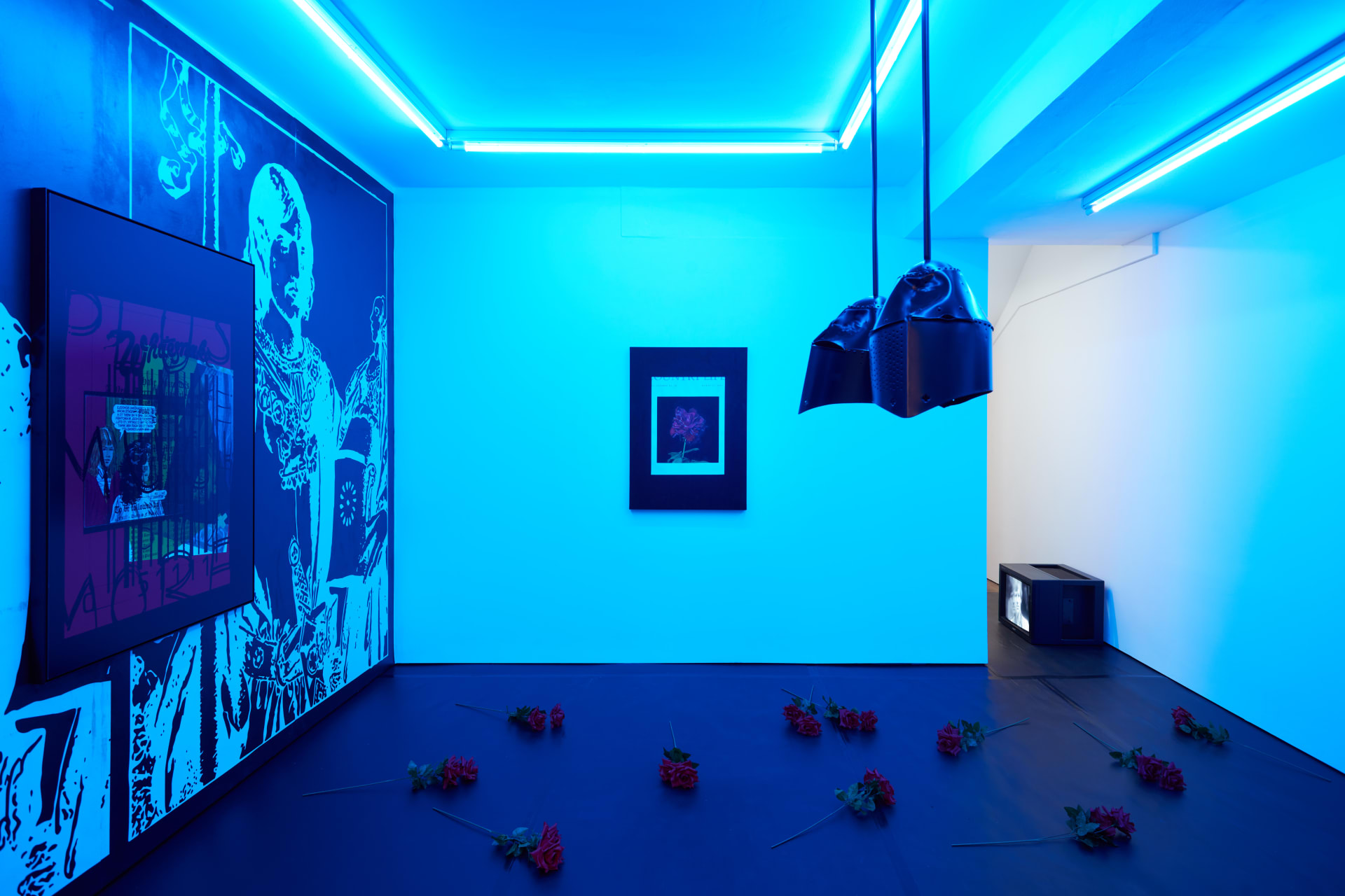 Installation images of Simeon Barclay's exhibition at Workplace in London, artworks, sculpture and video are cast in filtered blue light of a night club