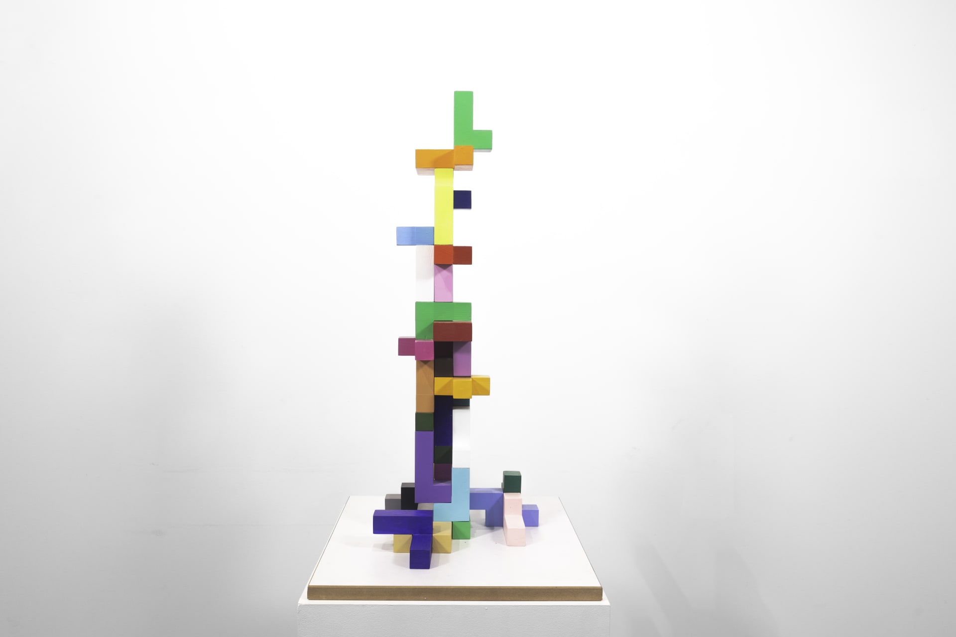 A sculpture by Jacob Dahlgren of multicoloured three-dimensional tetris pieces stacked in a tower