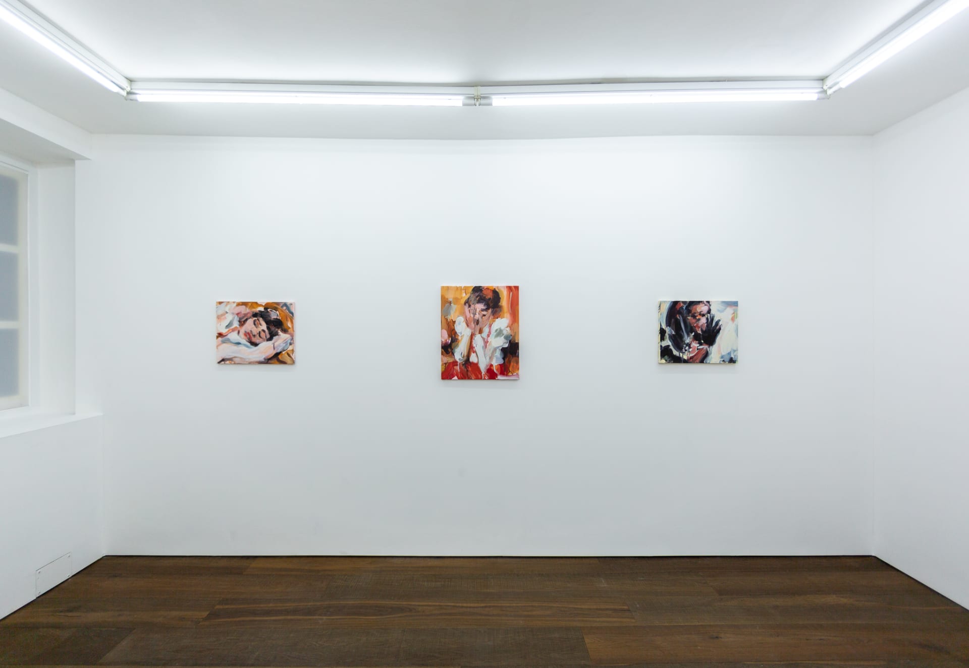 Installation shots of Laura Lancaster's solo show at Workplace London. Close up crop paintings of sleeping women and figures in landscapes, loosely painted.