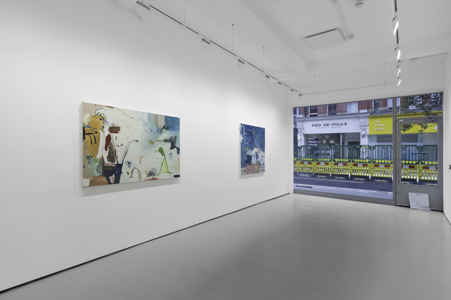 A white walled gallery with 4 artworks by b chehayeb hung on the walls