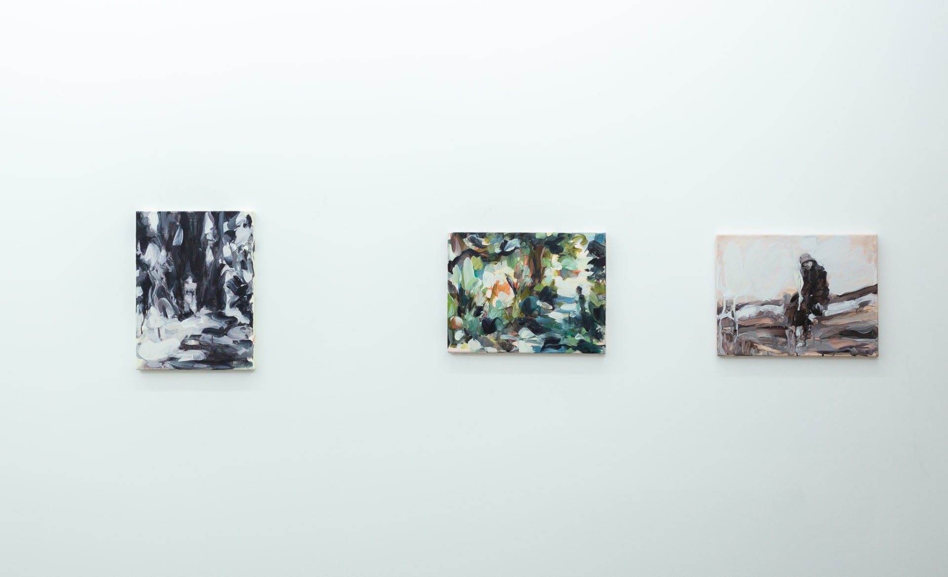 Installation shots of Laura Lancaster's solo show at Workplace London. Close up crop paintings of sleeping women and figures in landscapes, loosely painted.