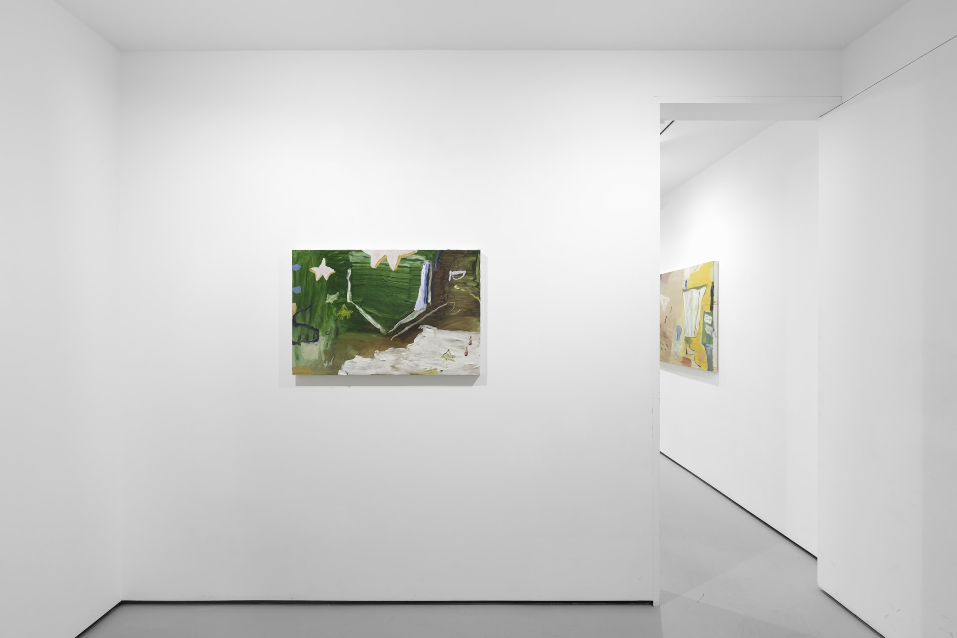 A white walled gallery with 4 artworks by b chehayeb hung on the walls