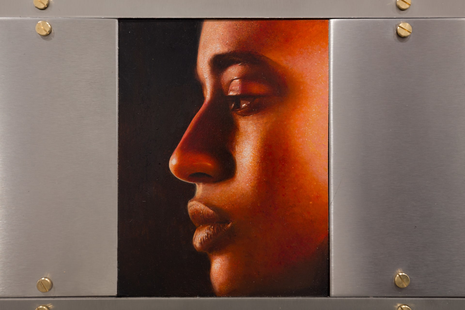 A painting by Ki Yoong of the side profile of a young man's face in a steel frame
