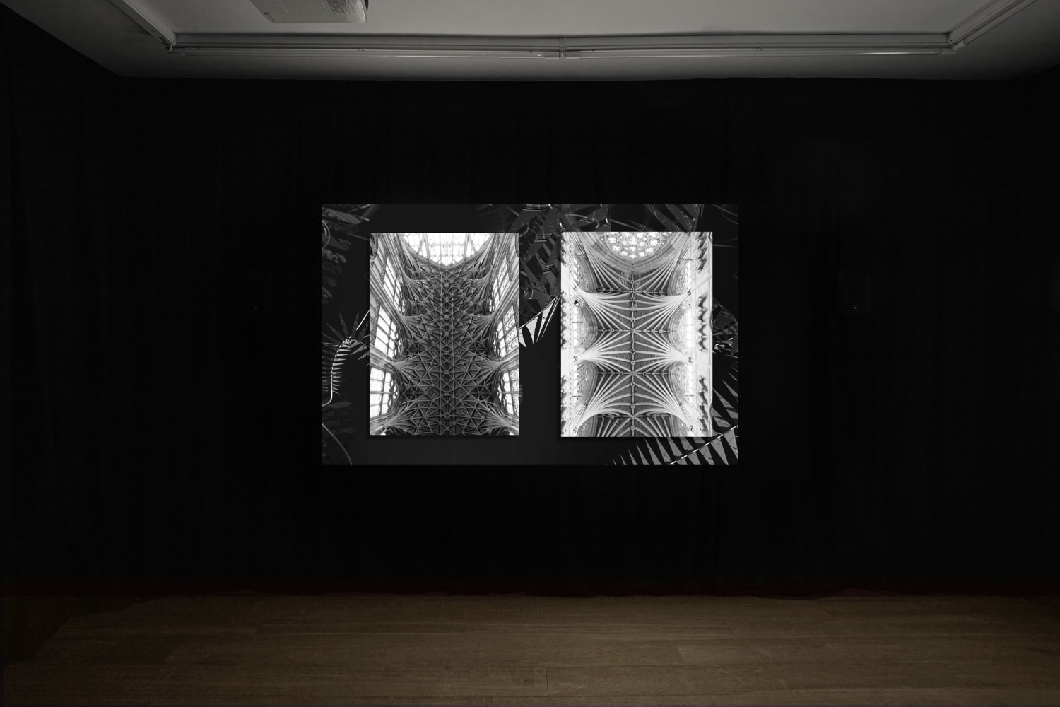 An installation image of Elizabeth Price's film in Workplace's gallery in Margaret Street - a black and white video collage image of two gothic ecclesiastical ceilings. 