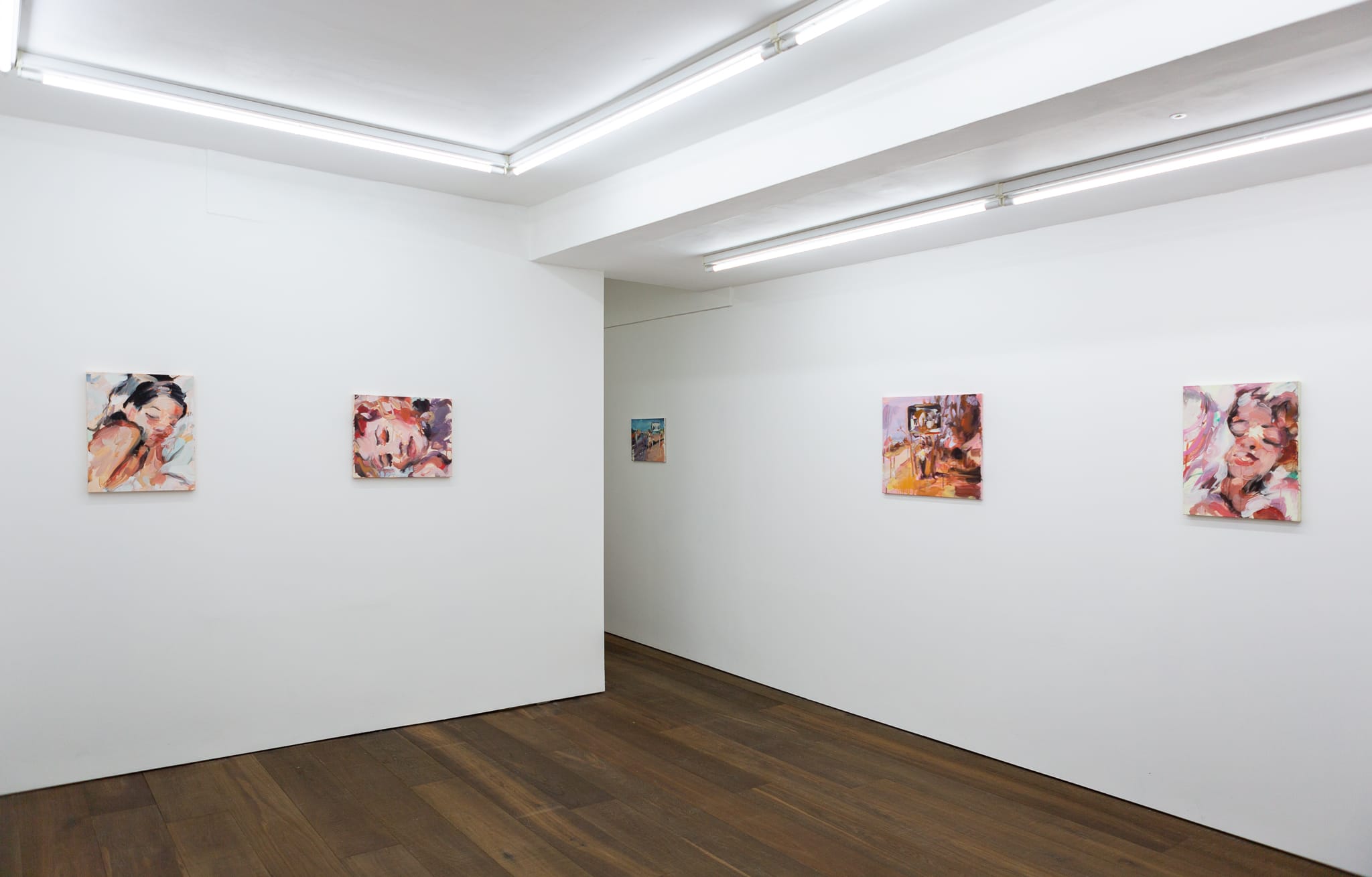 Installation shots of Laura Lancaster's solo show at Workplace London. Close up crop paintings of sleeping women and figures in landscapes, loosely painted.
