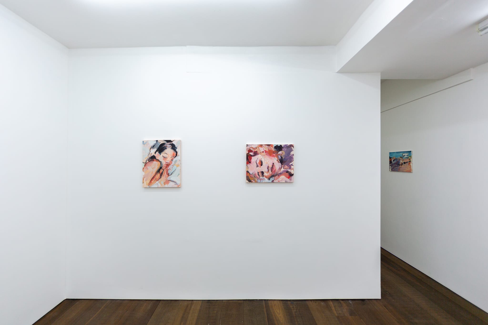 Installation shots of Laura Lancaster's solo show at Workplace London. Close up crop paintings of sleeping women and figures in landscapes, loosely painted.