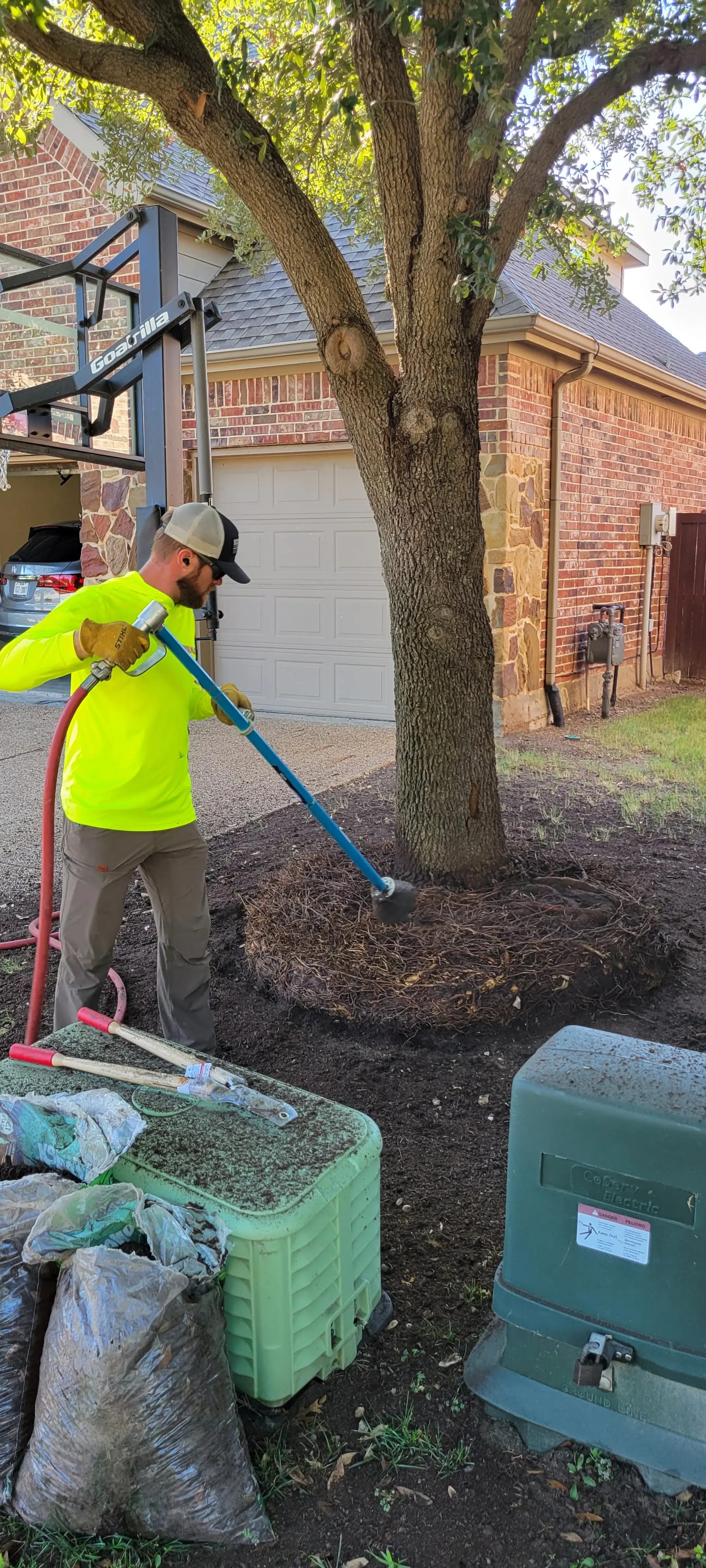Tree health treatment applied at the root zone of a residential tree
