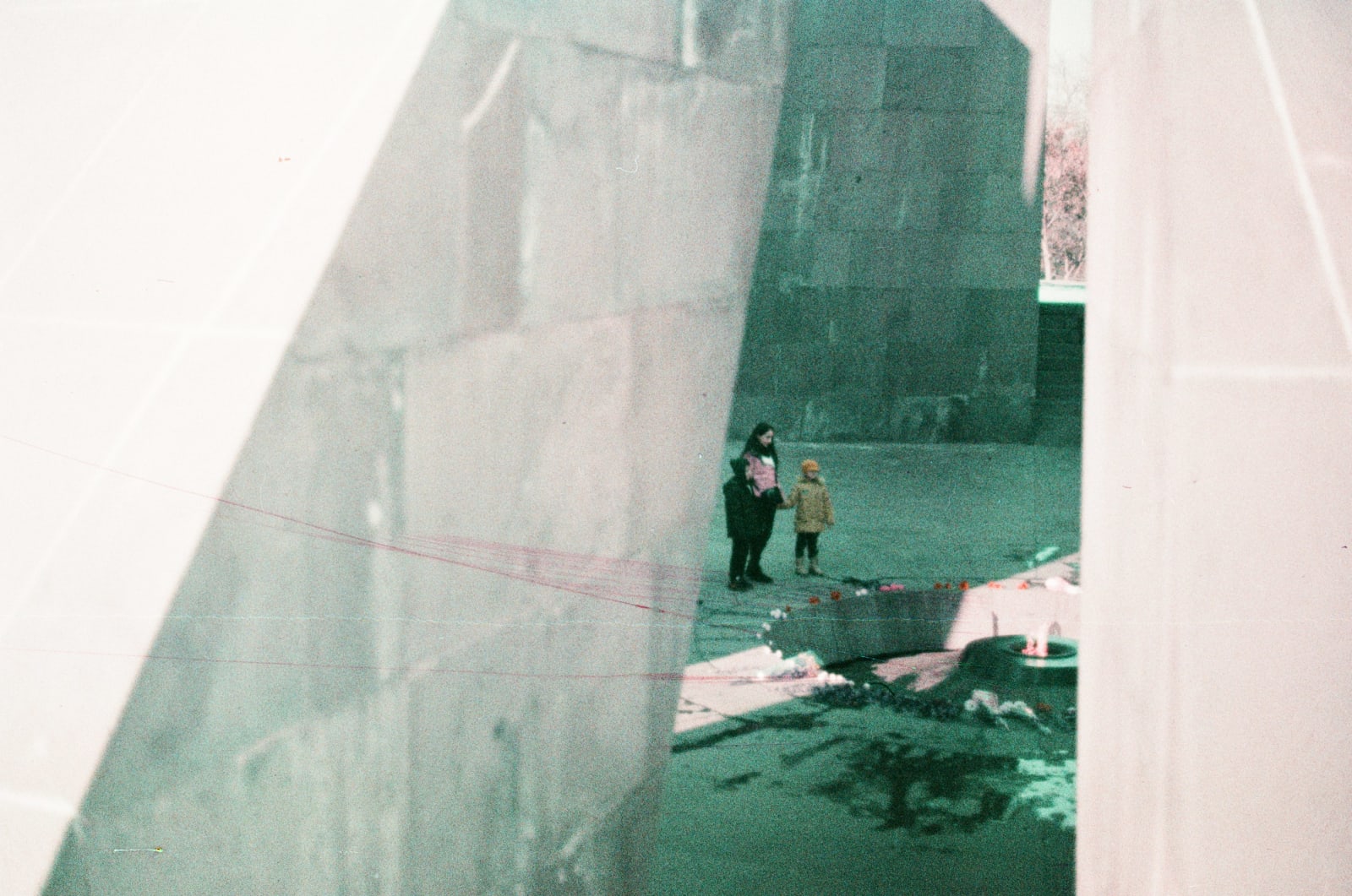 Family leaving flowers at the Eternal Fire in the Tsitsernakaberd Armenian Genocide Memorial Complex