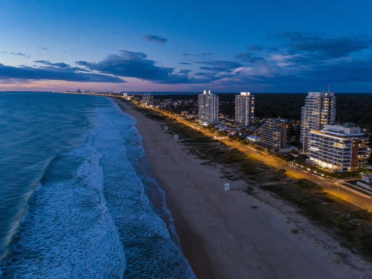 Aerial view of Punta del Este’s coastline and beachfront towers at dusk