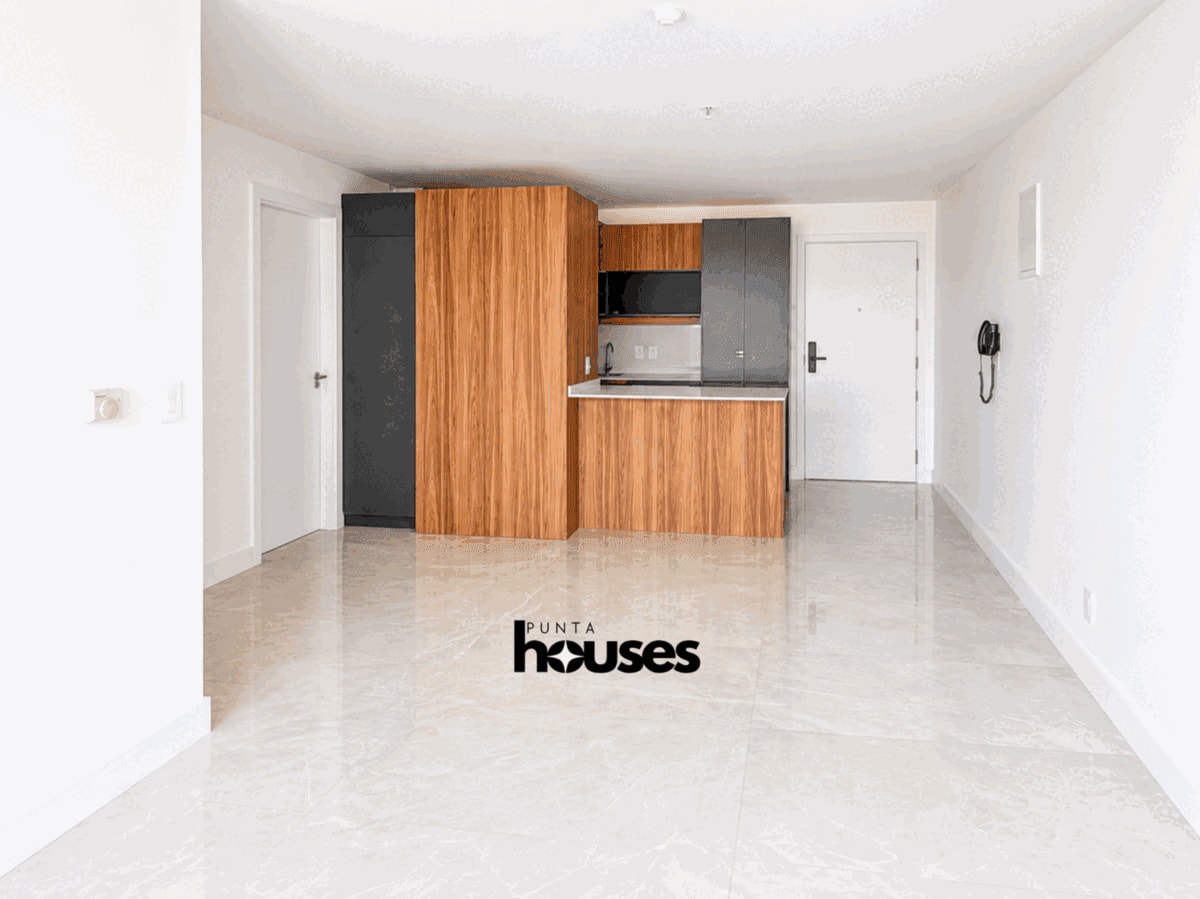 Bright open-plan living area with a modern integrated kitchen in a brand-new apartment for sale near Playa Brava.