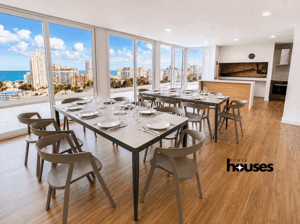 Spacious communal rooftop barbecue and dining area with panoramic views across Punta del Este and toward the Atlantic coast.