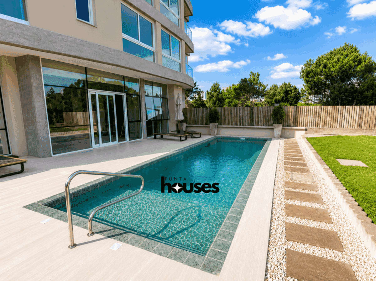 Landscaped outdoor swimming pool and sun terrace, ideal for enjoying the warmer months in Punta del Este.